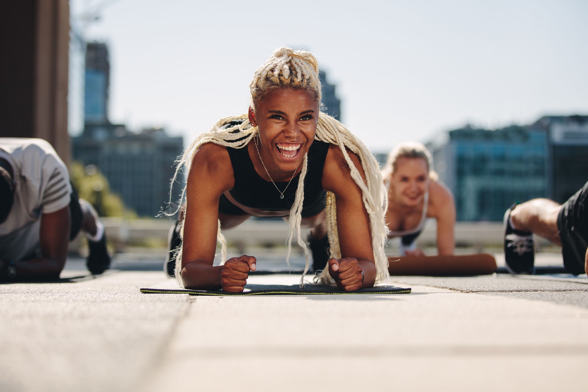 Group of people doing core exercise and laughing 