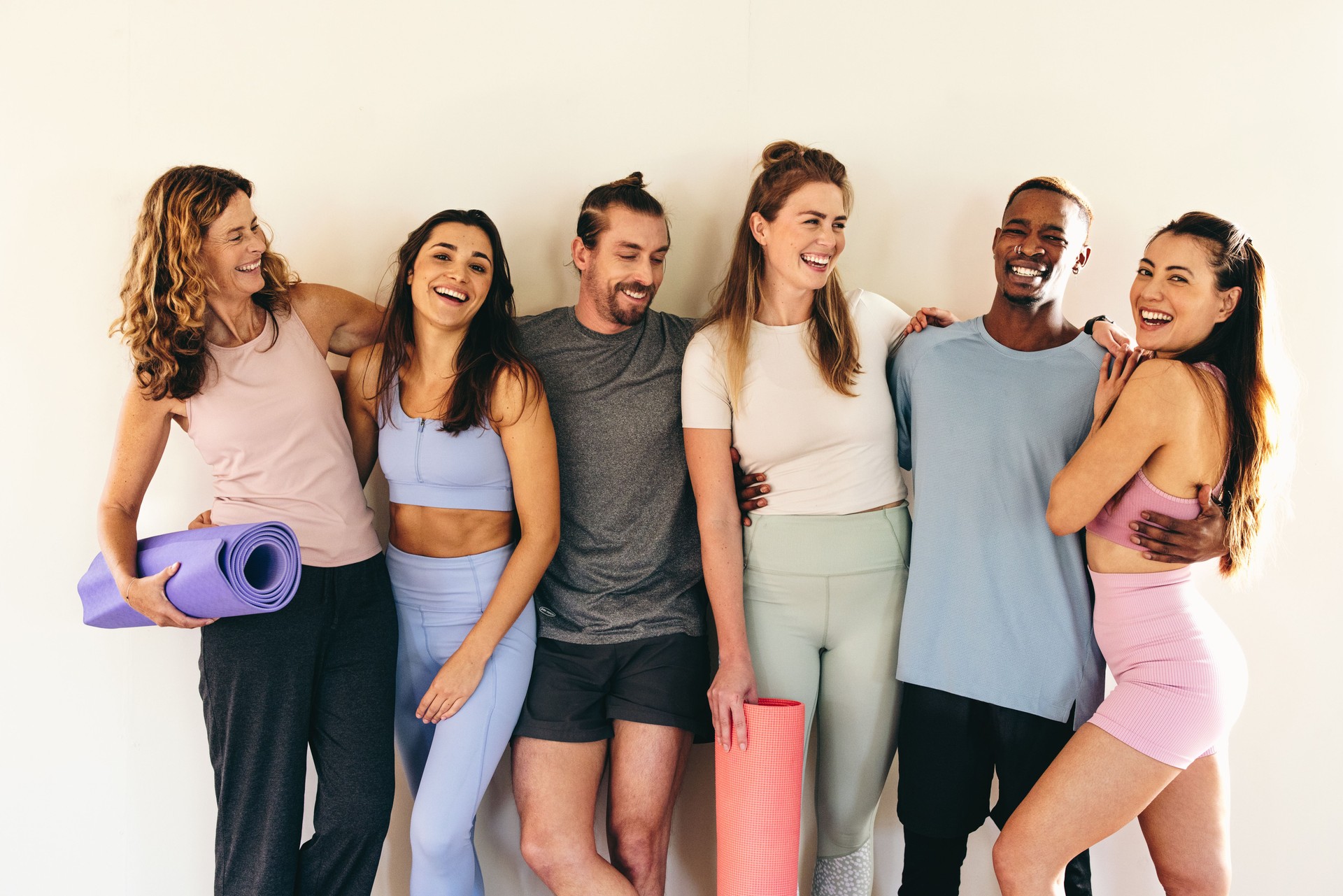 People standing as a group in a yoga studio